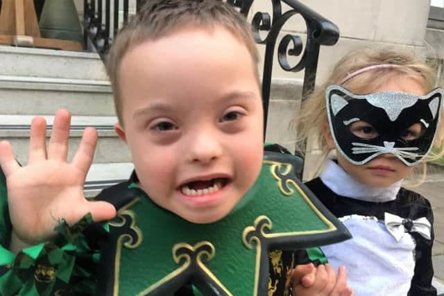 Harry and Ruby Archer dressed as a jester and a cat at the Portsmouth Down Syndrome Association Halloween party