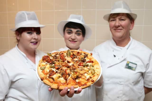 Mel Watson, Emily McClintock and Jelly Gieve with the Hotter Than Hell pizza