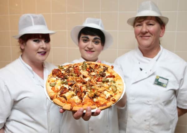 Mel Watson, Emily McClintock and Jelly Gieve with the Hotter Than Hell pizza
