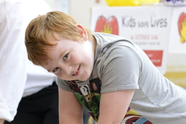 A youngster has a go at CPR