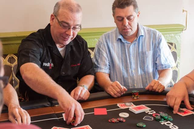 Regulars at the Star & Garter pub held a poker tournament for Macmillan Cancer Support. Paul Goater, left, the organiser of the event, places a bet with Nik Martin 					    Picture: Keith Woodland (161391-015)