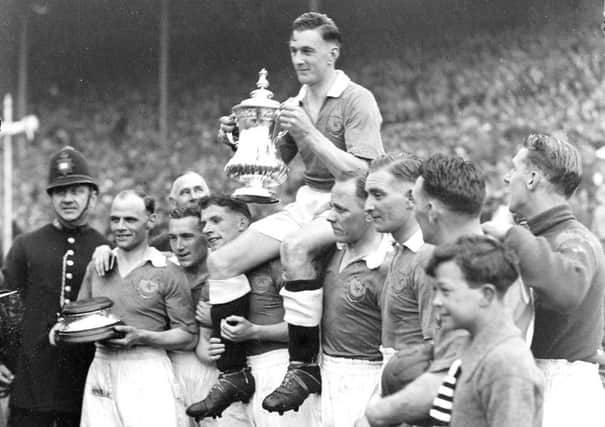 Pompey's 1939 FA Cup winning-captain Jimmy Guthrie being carried by his Blues team-mates
