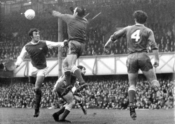 John Milkins challenges Ray Kennedy whilst Fred Smith and Eoin Hand look on. Picture: Pompey History Society Archive