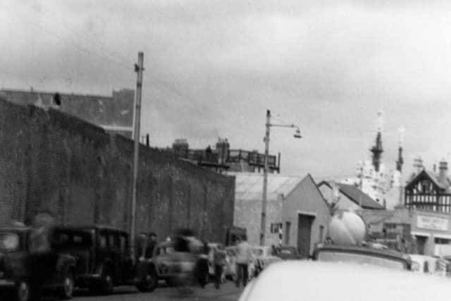The superstructure of the battleship HMS Vanguard looms over The Seagull pub in Broad Street, Old Portsmouth. (Eddie Wallace)