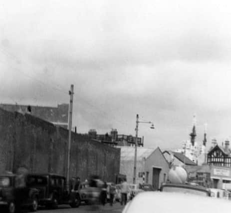 The superstructure of the battleship HMS Vanguard looms over The Seagull pub in Broad Street, Old Portsmouth. (Eddie Wallace)