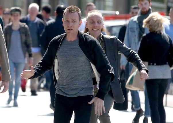 Actors Ewan McGregor (front) and Ewan Bremner (behind) running through the streets of Edinburgh where scenes for the new Trainspotting 2 is being filmed.