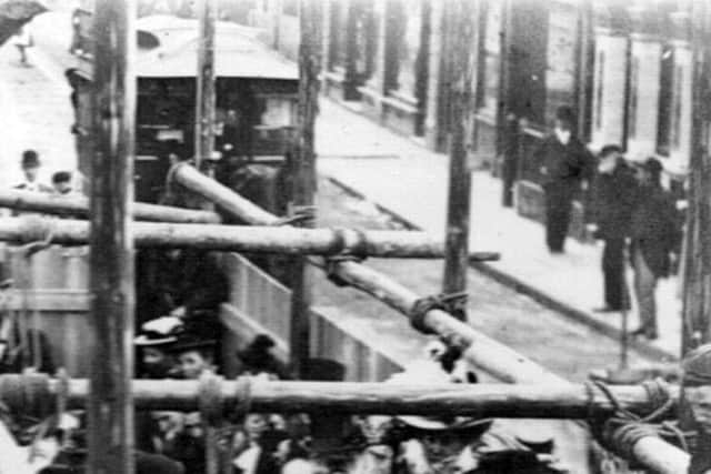 SCAFFOLD This street picture is somewhere in Portsmouth, but where? Behind the wooden scaffolding poles held together with rope is a horse-drawn tram. Picture: The Barry Cox Collection