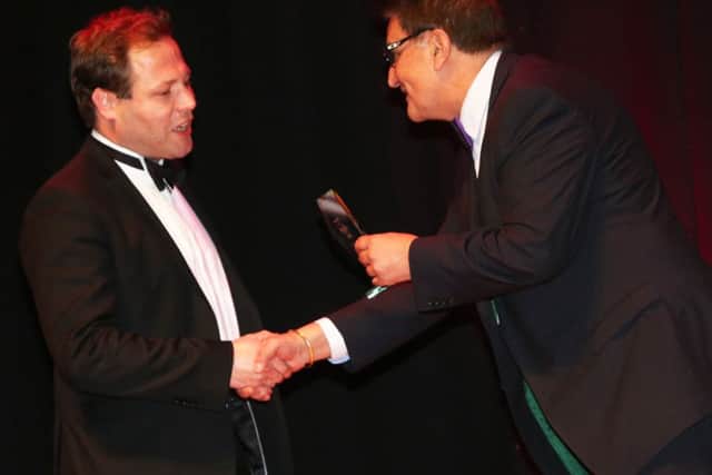 Dr Eliot Wilkinson being handed his Hospital Doctor of the Year award