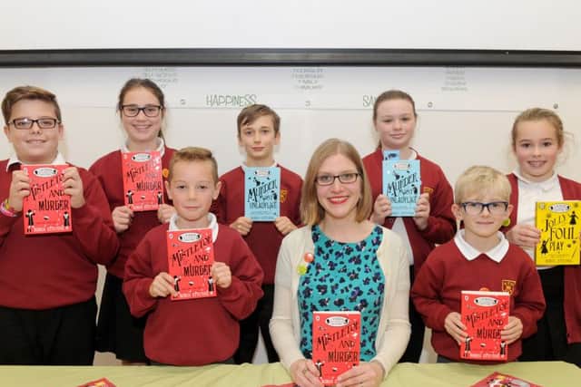 Author Robin Stevens with, from left, Liam Timberlake, Ella Spacey, Daniel Porton, Rhys Jenkins, Keira Colwell, Toby Goodhew and Ella Jenner
Picture: Sarah Standing (161512-1291)