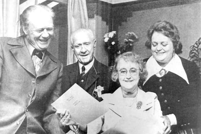 Actress Ann Noble and her husband, Lester Philcox (left), show stills from their latest picture to Ann's parents, Mr and Mrs P  Noble-Airy