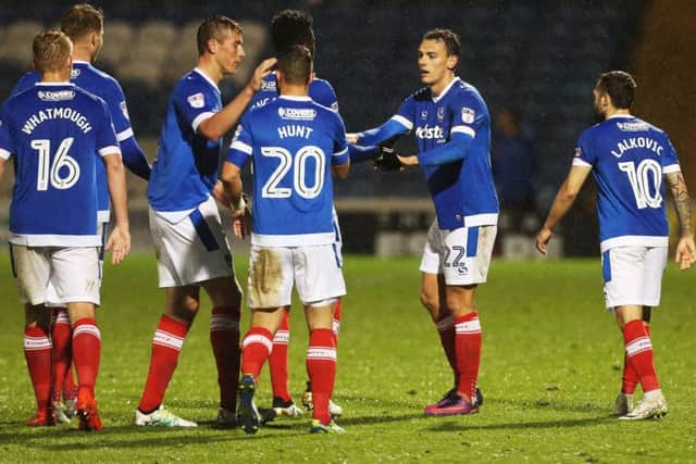 Pompey players congratulate Kal Naismith, second from right, after his winning goal in the Checkatrade Trophy against Bristol Rovers   Picture: Joe Pepler