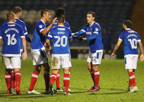Pompey players congratulate Kal Naismith, second from right, after his winning goal in the Checkatrade Trophy against Bristol Rovers   Picture: Joe Pepler