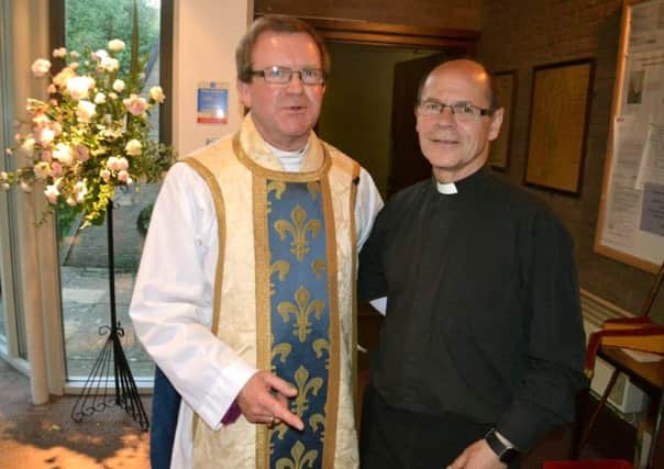 PRIDE The Rev Peter Lambert, right, after he was licensed as assistant deanery priest by Bishop Christopher Foster, left