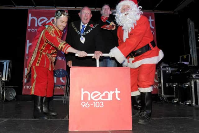 From left, Marcus Patrick, the deputy Lord Mayor of Portsmouth Cllr Ken Ellcome, News columnist Warren Hayden from Heart and Father Christmas turn on the lights.Picture: Sarah Standing (161547-1758)