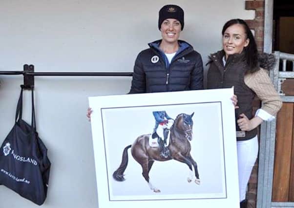 Bethany Vere shows her picture of Valegro to gold medal winner Charlotte Dujardin