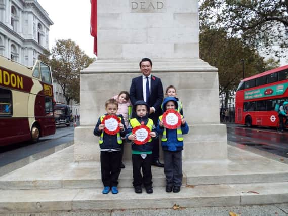 TRIBUTE Alan Mak with pupils from Springwood Infant School at the Cenotaph in Whitehall