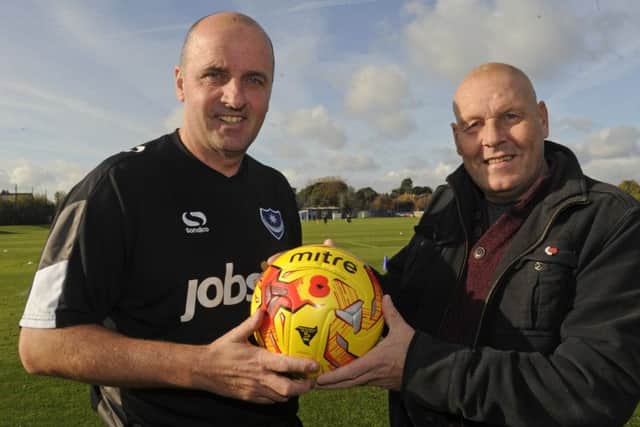 Pompey manager Paul Cook, left, receives the Remembrance Day match day ball from Pompey Pirate Craig Bryden.
Picture Ian Hargreaves (161283-1)