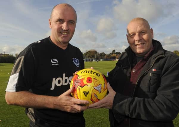 Pompey manager Paul Cook, left, receives the Remembrance Day match day ball from Pompey Pirate Craig Bryden. 
Picture Ian Hargreaves (161283-1)