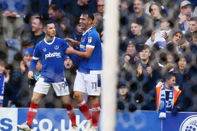 Gary Roberts celebrates putting Pompey ahead from the spot with Conor Chaplin Picture: Joe Pepler