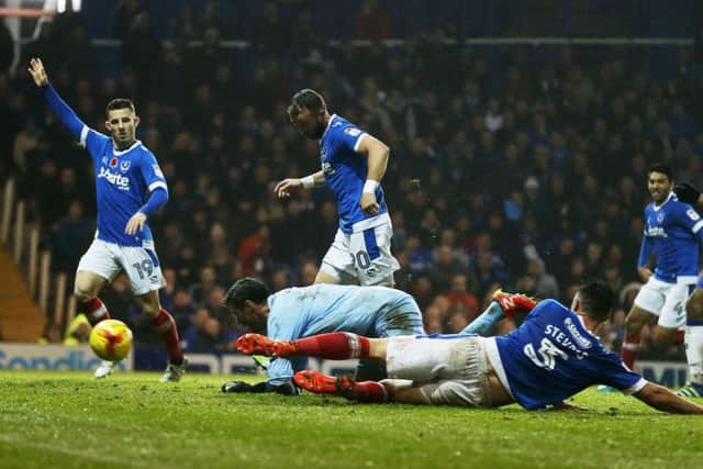 Noel Hunt scores his first goal for Pompey in yesterday's 4-0 win against Mansfield Picture: Joe Pepler