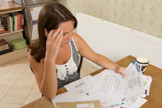 An actor is a posed picture highlighting debt problems, which is on the rise across the Portsmouth area