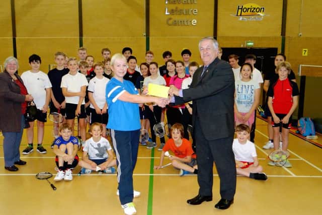 Havant Lions' Mike Tudor presents the donation to Havant Junior Badminton Club secretary and coach Maggie Phillips