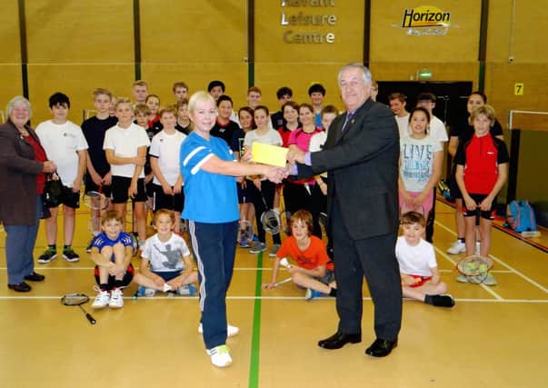 Havant Lions' Mike Tudor presents the donation to Havant Junior Badminton Club secretary and coach Maggie Phillips