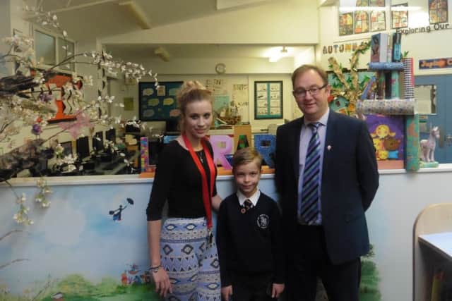 Jacob Smith with his teacher Aimie Ridd and head teacher Colin Flanagan at St Thomas More Primary School PPP-161114-133011001