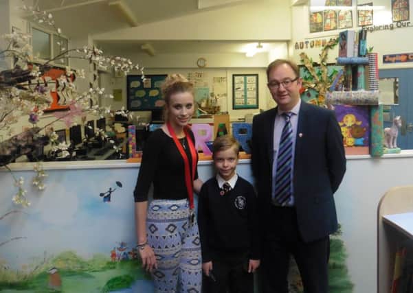 Jacob Smith with his teacher Aimie Ridd and head teacher Colin Flanagan at St Thomas More Primary School PPP-161114-133011001