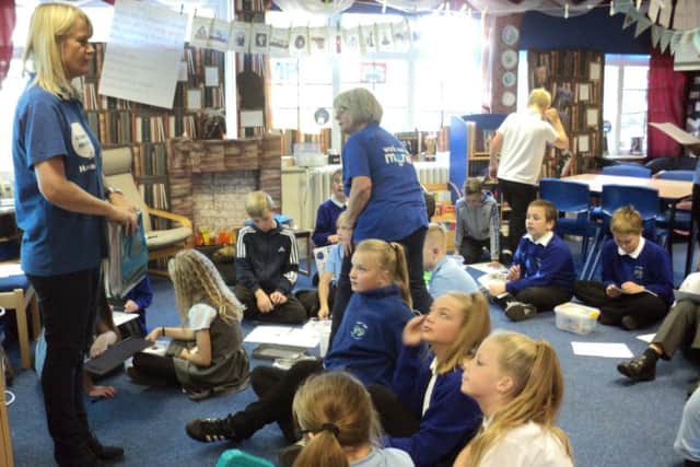 Fiona Ross in the blue T-shirt at the front of the class and Brenda Abbott one of our volunteers, helping the Year 6 class of Front Lawn Primary Academy