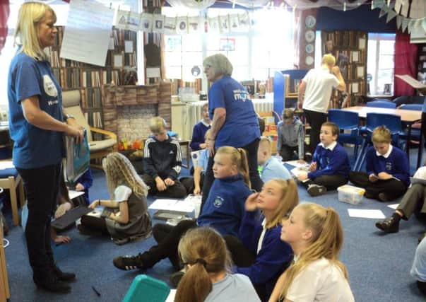 Fiona Ross in the blue T-shirt at the front of the class and Brenda Abbott one of our volunteers, helping the Year 6 class of Front Lawn Primary Academy