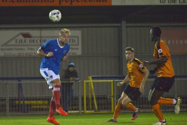 Jack Whatmough heads clear for Pompey against Wolves at Westleigh Park. Picture: Colin Farmery