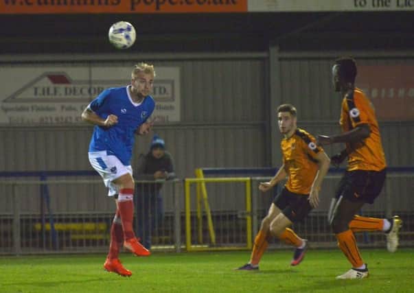 Jack Whatmough heads clear for Pompey against Wolves at Westleigh Park. Picture: Colin Farmery