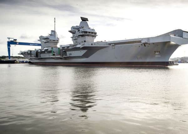 Stock Picture:
The UK's largest ever warship, HMS Queen Elizabeth, has today been successfully floated out of the dock in which she was assembled.
In an operation that started earlier this week, the dry dock in Rosyth near Edinburgh was flooded for the first time to allow the 65,000 tonne aircraft carrier to float. It then took only three hours this morning to carefully manoeuvre HMS QUEEN ELIZABETH out of the dock with just two metres clearance at either side and then berth her alongside a nearby jetty.
Teams will now continue to outfit the ship and steadily bring her systems to life in preparation for sea trials in 2016. The dock she vacates will be used for final assembly of her sister ship, HMS PRINCE OF WALES, which will begin in September.
The float out of HMS QUEEN ELIZABETH comes just 13 days after the vessel was named by Her Majesty the Queen in a spectacular ceremony.
HMS QUEEN ELIZABETH and HMS PRINCE OF WALES are being delivered by the Aircraft Carrier Alliance, a unique partnership between