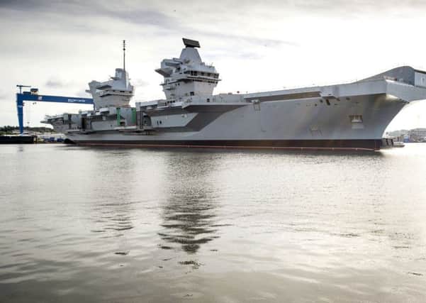 Stock Picture:

The UK's largest ever warship, HMS Queen Elizabeth, has today been successfully floated out of the dock in which she was assembled.

In an operation that started earlier this week, the dry dock in Rosyth near Edinburgh was flooded for the first time to allow the 65,000 tonne aircraft carrier to float. It then took only three hours this morning to carefully manoeuvre HMS QUEEN ELIZABETH out of the dock with just two metres clearance at either side and then berth her alongside a nearby jetty.

Teams will now continue to outfit the ship and steadily bring her systems to life in preparation for sea trials in 2016.  The dock she vacates will be used for final assembly of her sister ship, HMS PRINCE OF WALES, which will begin in September.

The float out of HMS QUEEN ELIZABETH comes just 13 days after the vessel was named by Her Majesty the Queen in a spectacular ceremony.

HMS QUEEN ELIZABETH and HMS PRINCE OF WALES are being delivered by the Aircraft Carrier Alliance, a unique partnership between
