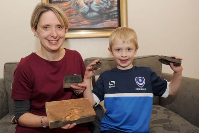 Andrea Wingfield with her son Toby Wingfield and the fire bomb that was found along with some of the damaged wood from the loft
Picture: Sarah Standing (161564-6891)