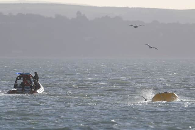 The Royal Navy tow out a second World War bomb found while dredging the harbour in Portsmouth
Picture: Steve Parsons/PA Wire