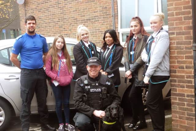 (LtoR back row) PCSO Jim Elgar, Miltoncross School pupil Kayleigh Wilson with Portsmouth Academy for Girls pupils Mollie Robinson, Maesha Uddin, Leah Casey and Saraya Jeffery. (in front) PC Darren Coupland from the dog unit.  Picture: Ellie Pilmoor.