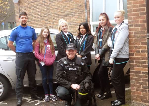 (LtoR back row) PCSO Jim Elgar, Miltoncross School pupil Kayleigh Wilson with Portsmouth Academy for Girls pupils Mollie Robinson, Maesha Uddin, Leah Casey and Saraya Jeffery. (in front) PC Darren Coupland from the dog unit.  Picture: Ellie Pilmoor.