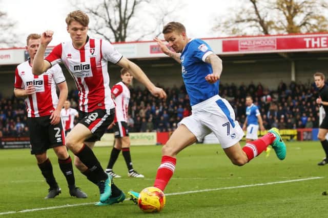 Carl Baker fires in a cross against Cheltenham