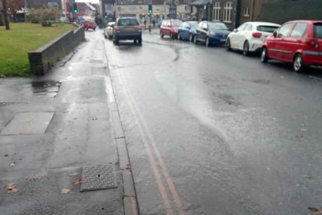 Rainwater streams down London Road near to its junction with Havant Road