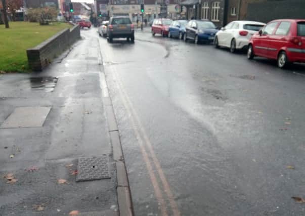 Rainwater streams down London Road near to its junction with Havant Road