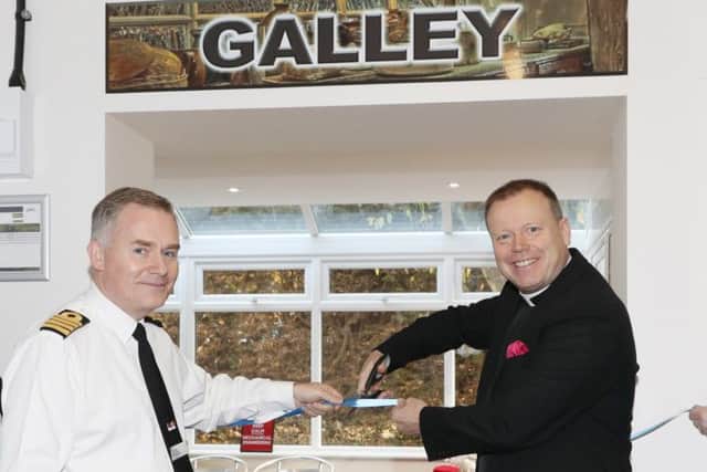 Captain Peter Towell, commanding officer of HMS Sultan, assists Royal Navy Chaplain of the Fleet, The Venerable Ian Wheatley, in opening the new galley at The Haven