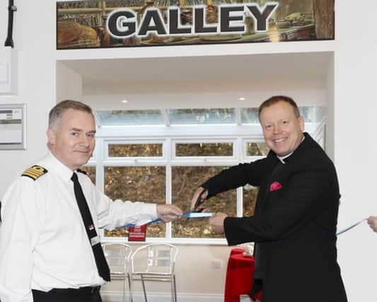 Captain Peter Towell, commanding officer of HMS Sultan, assists Royal Navy Chaplain of the Fleet, The Venerable Ian Wheatley, in opening the new galley at The Haven