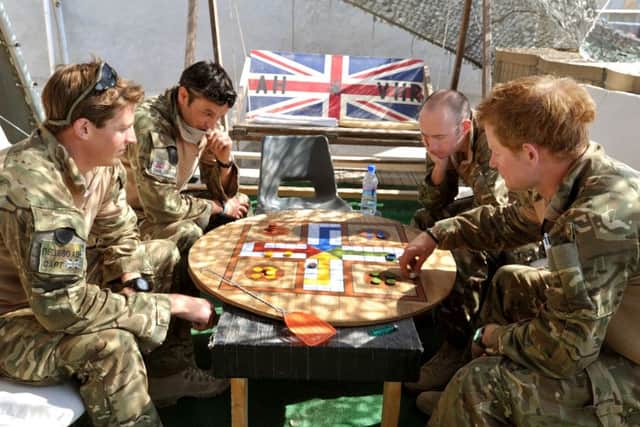 Prince Harry playing uckers while on duty in November 2012. Picture credit: John Stillwell/PA Wire