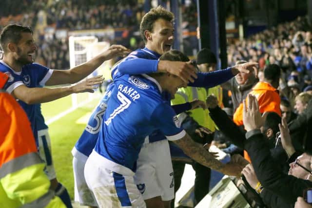 Kal Naismith, centre, is congratulated by his team-mates after sealing Pompeys 3-1 win at Luton Picture: Joe Pepler