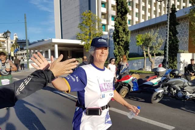 Clare Martin running the Athens Marathon for Pompey in the Communitys new minibus