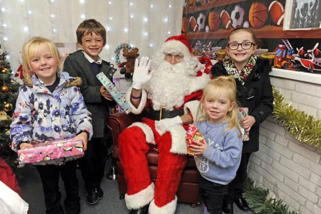 From left, Payton Price, five, her brother Joey Price, seven, Father Christmas, Lacie-Mai Stray, two, and Olivia Stevens, five Picture: Ian Hargreaves (161338-13)