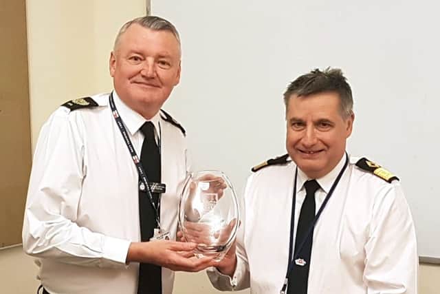 CPO George Mitchell accepting his leaving gift from Commodore Duncan Lamb