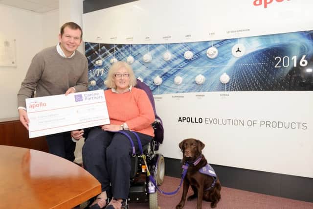 Peter Browitt, finance director, presenting the cheque to Pam Quick and her dog Alucia on behalf of Canine Partners
Picture: Sarah Standing